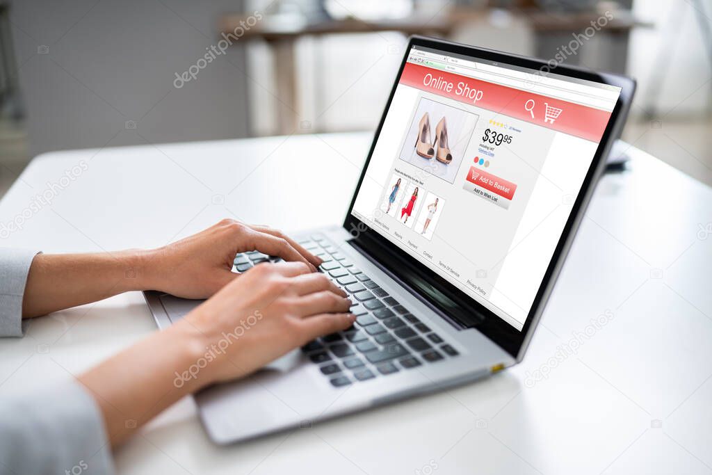 Close-up Of Woman Shopping Footwear's Online On Laptop At Home