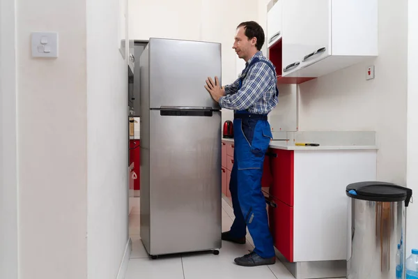 Young Male Mover Placing Steel Refrigerator Kitchen — Stock Photo, Image