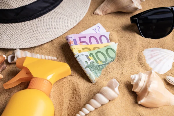 Euros In Sand On Beach Surrounded By Objects