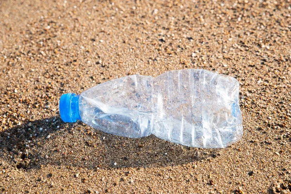 Plastic Pollution In Sea. Plastic Bottle On Sea Shore