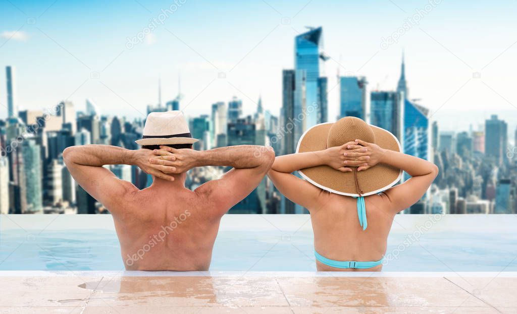 Couple In Infinite Swimming Pool With Dubai Skyline In Background