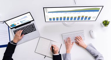 İşyerindeki Bilgisayarda Grafik İncelemesi Yapan İki İşadamı