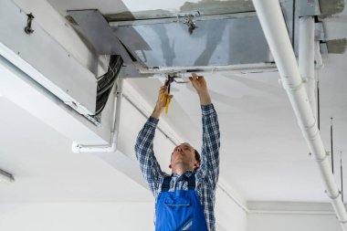 Plumber Repairing Water Pipes In Residential Building clipart