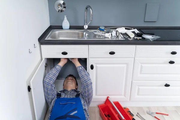 Male Plumber Overall Fixing Kitchen Sink Pipe — Stock Photo, Image