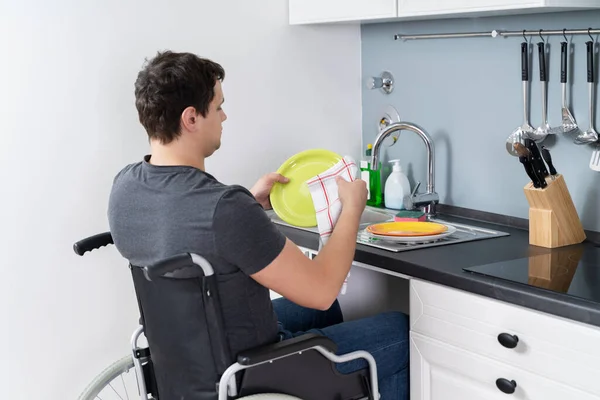 Hombre Discapacitado Sentado Silla Ruedas Lavando Limpiando Platos Cocina —  Fotos de Stock