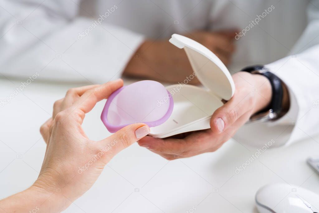 Gynecologist Consulting Woman On Diaphragm Contraception And Birth Control Method