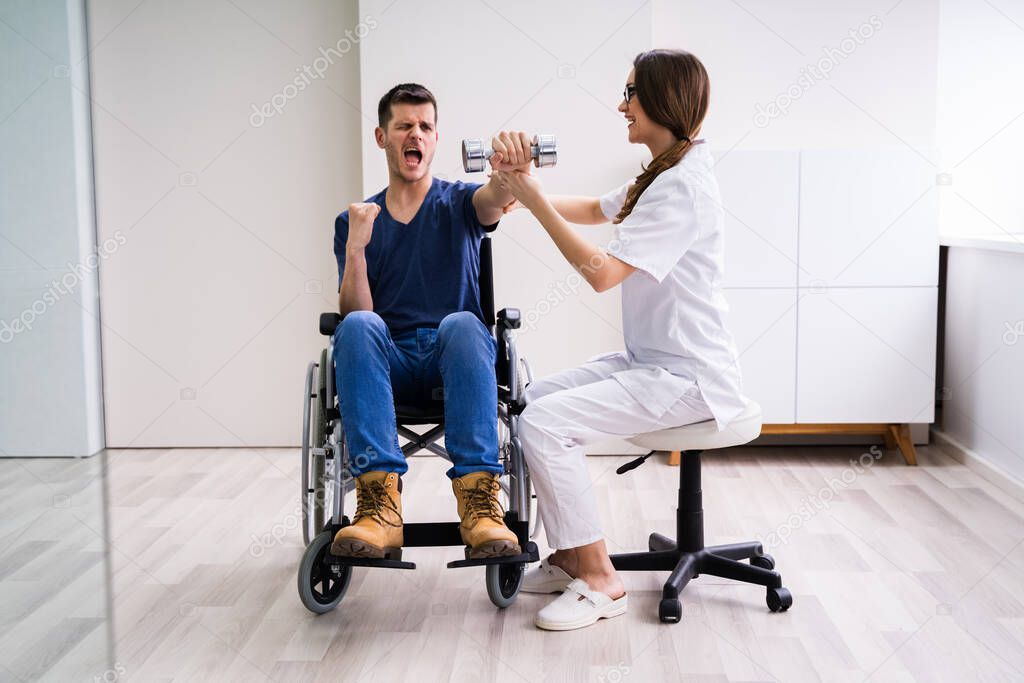Therapist Assisting Happy Male Patient While Exercising With Dumbbell