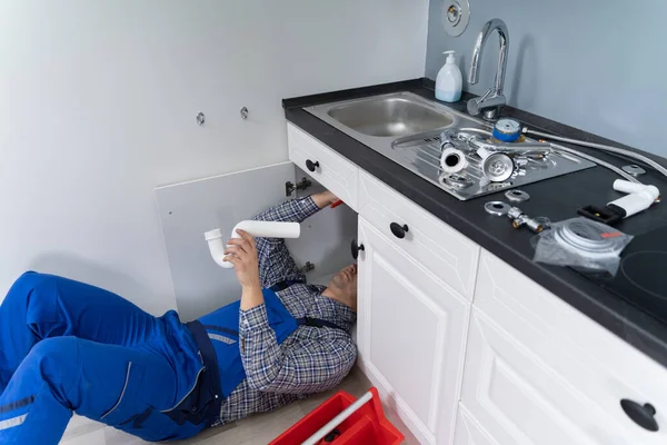 Male Plumber Overall Fixing Kitchen Sink Pipe — Stock Photo, Image