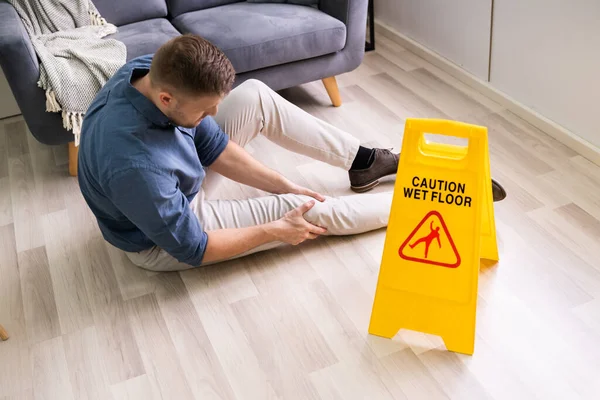 Man Falling Wet Floor Front Caution Sign Home — Stock Photo, Image
