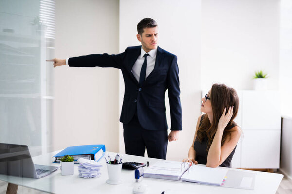 Boss Firing Female Employee In Modern Office