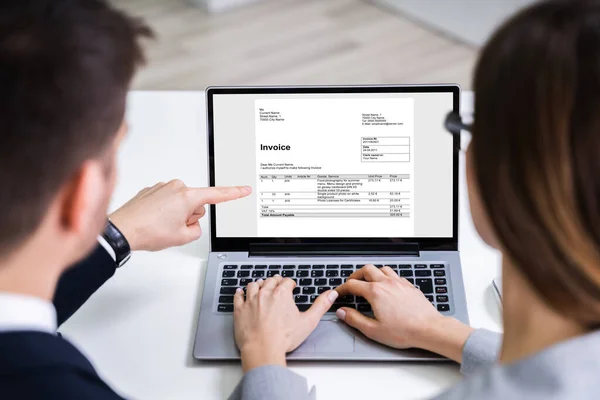 Two Businesspeople Analyzing Invoice Laptop Office — Stock Photo, Image