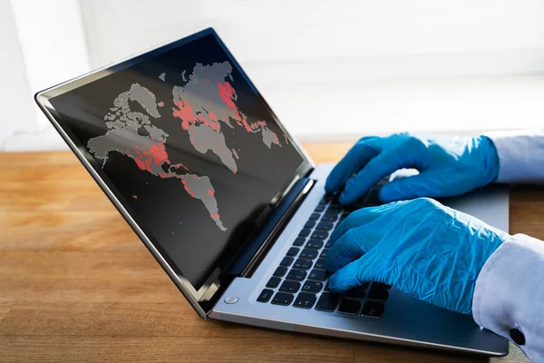 Checking Coronavirus Infection Worldwide Map On Laptop