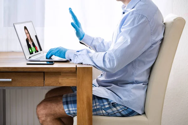 Businessman Dressed In Shirt And Shorts Having Video Call On Computer In The Home Office