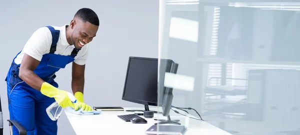 Young Male Maid Cleaning Glass Desk Feather Duster Office — Stock Photo, Image