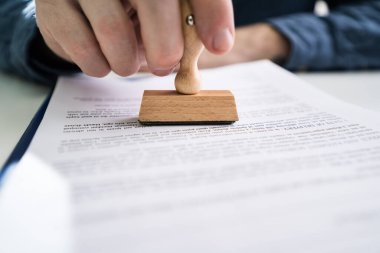 Yakın çekim kişi el Stamper belgeyle onaylanan metin kullanma