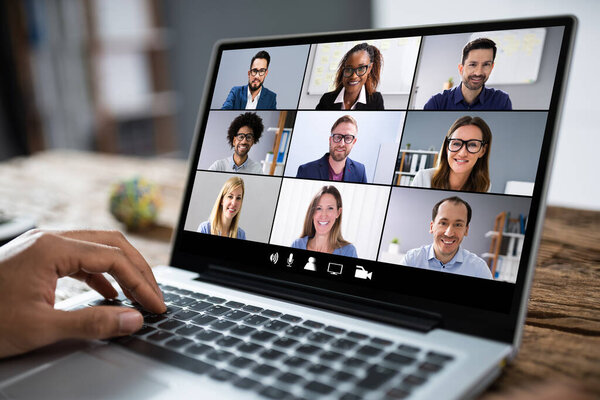 Man Working From Home Having Online Group Videoconference On Laptop