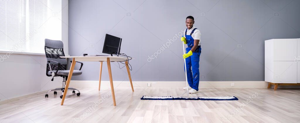 Man With Mop And Wet Floor Sign