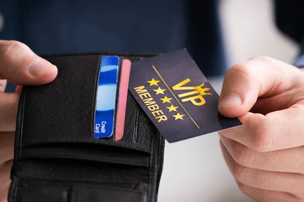 Close-up Of A Person\'s Hand Removing VIP Member Card From Wallet