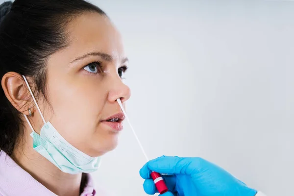 Doctor Taking Mouth Fluid Swab Sample From Throat