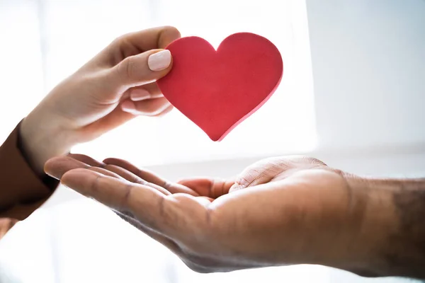 Close Woman Giving Red Heart Man Hand — Stock Photo, Image