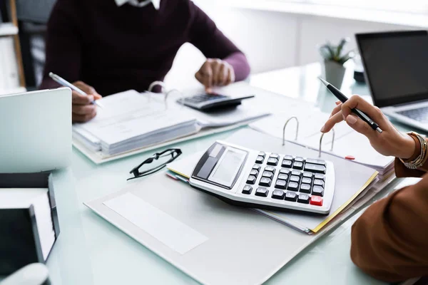 Close Two Businesspeople Calculating Financial Statement Desk — Stok Foto