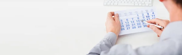 Man Looking Calendar Marking Date Desk — Stock Photo, Image