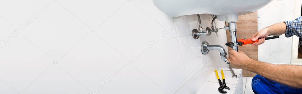 Plumber Plumbing Bathroom Sink And Doing Toilet Fix Service