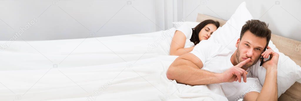 Cheating Man Privately Talking While Wife Sleeping In Bed
