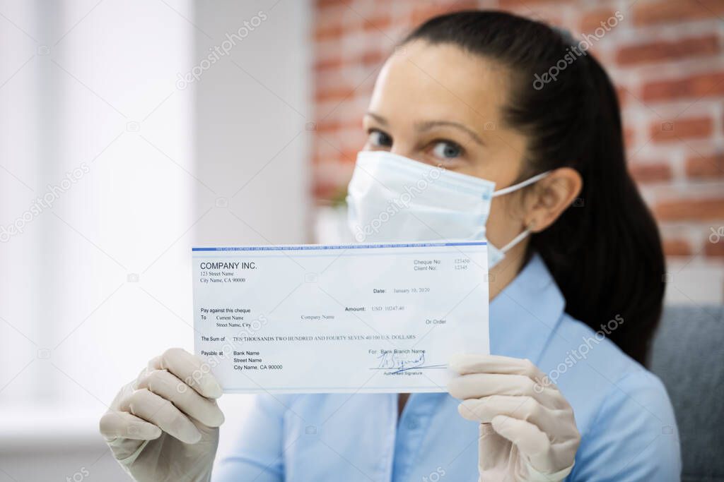 Woman In Face Mask Holding Paycheck Or Stimulus Check 