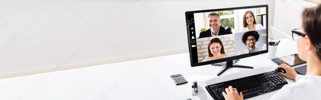 Woman Working From Home Having Online Group Videoconference On Laptop