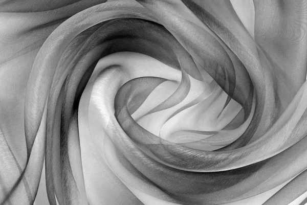 Скрученный вихрь из ткани органзы серой текстуры — стоковое фото