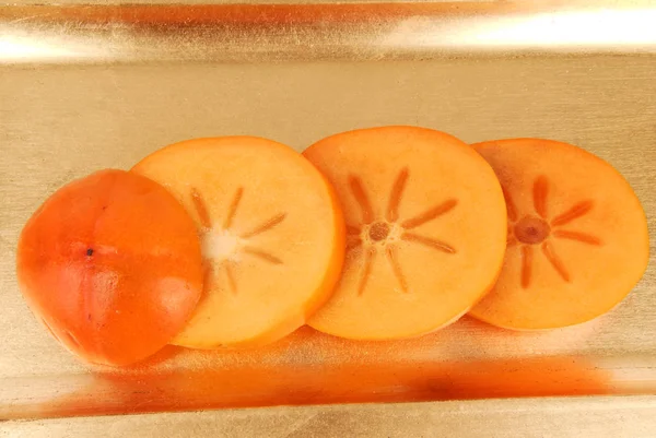 Persimmon Fruit Slices Golden Plate — Stock Photo, Image