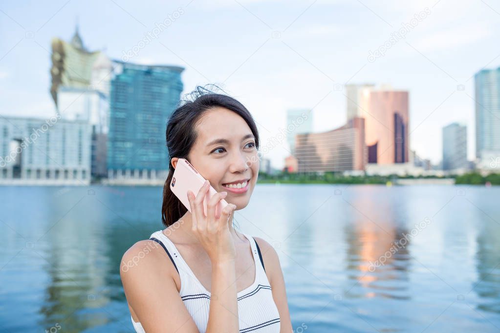 Woman talking on cellphone in city