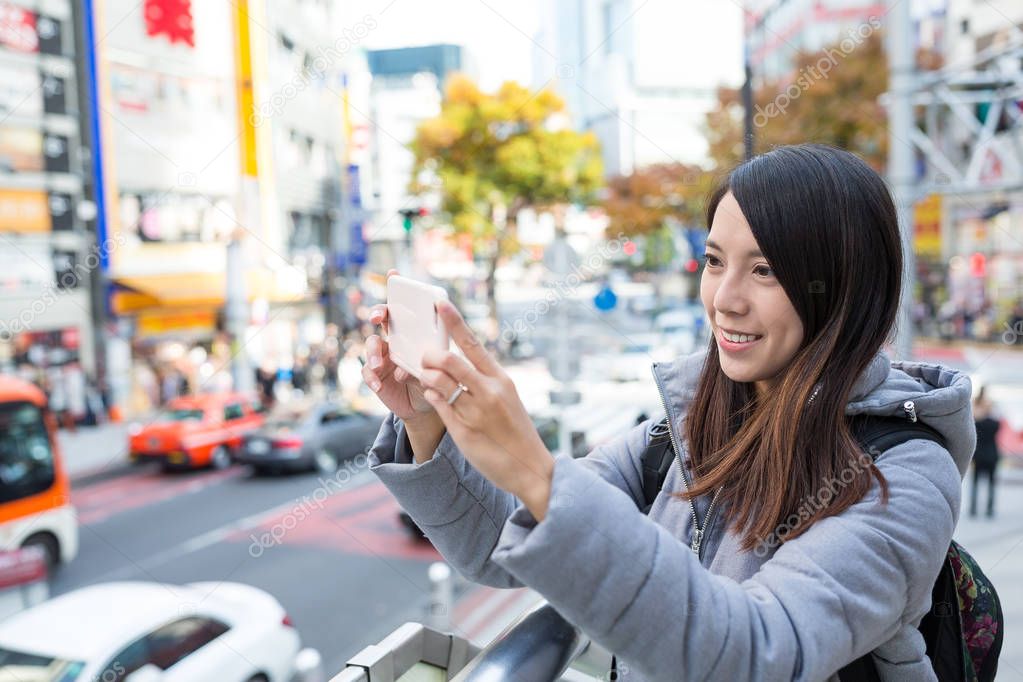 Woman taking photo in Tokyo
