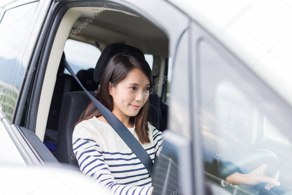 Young woman driving her car 