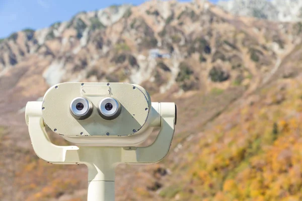 Coin binoculars in mountains