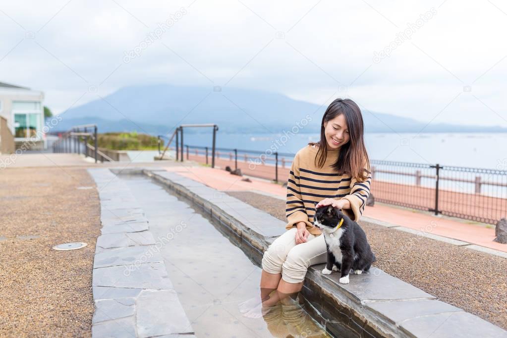 Woman touching the street cat
