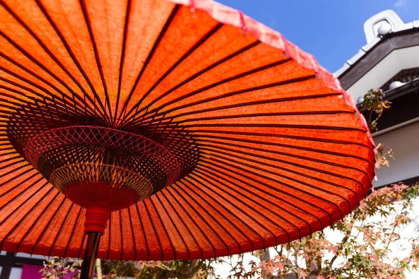Японский красный зонтик осенью — стоковое фото