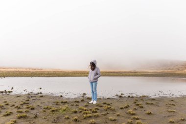 Woman in marsh at winter  clipart