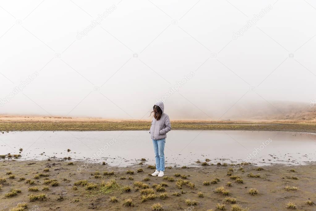 Woman in marsh at winter 