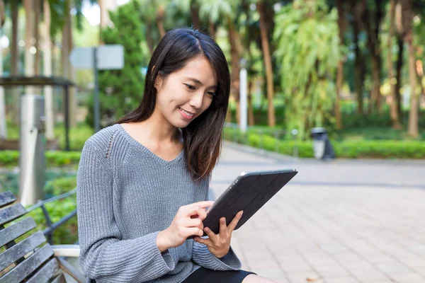 Woman using digital tablet at park — Stock Photo, Image