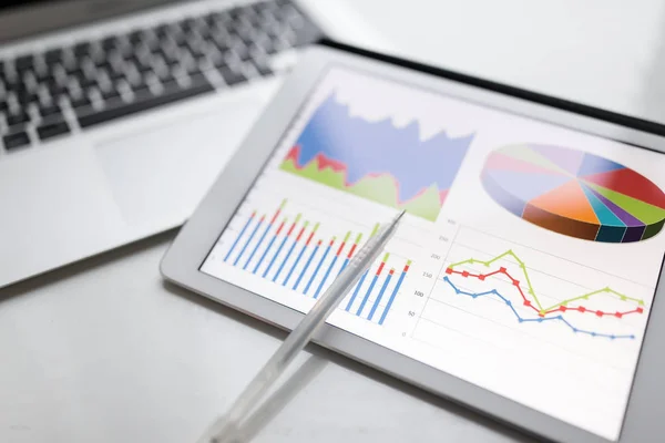 Tablet with chart on table in office — Stock Photo, Image