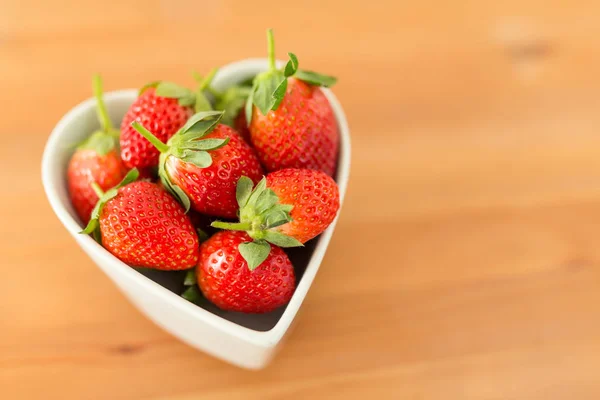 Färska jordgubbar i hjärtat form skål — Stockfoto