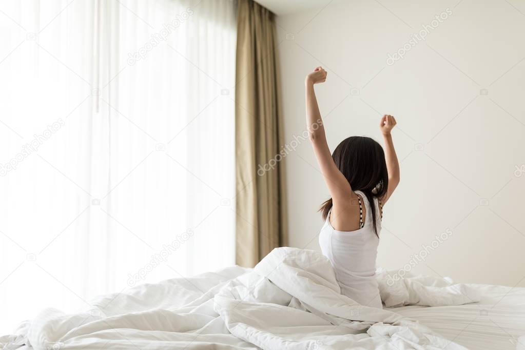 Woman stretching in bed after wake up