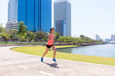 Woman running at city clipart