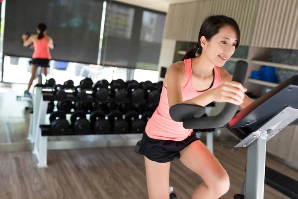 Woman doing sport biking in the gym for fitness — Stock Photo, Image