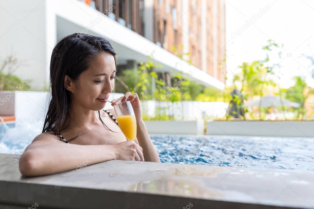 Woman enjoy her drink in swimming pool