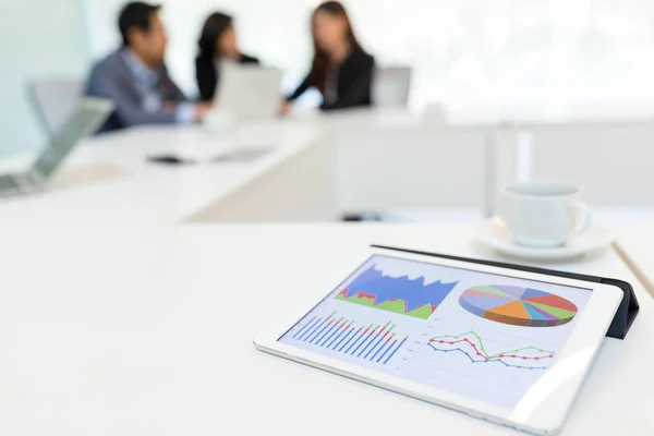 Digital tablet showing data chart in meeting room — Stock Photo, Image