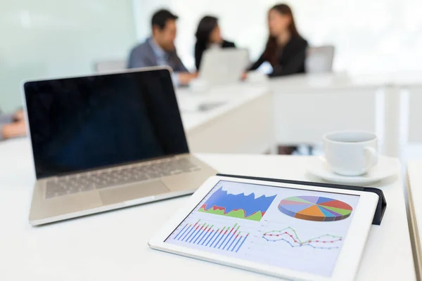 Business chart showing on tablet computer with businesspeople discuss — Stock Photo, Image