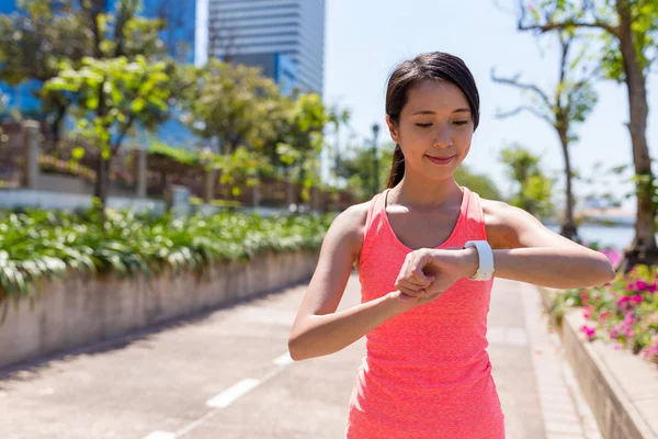 Woman using smart watch for running